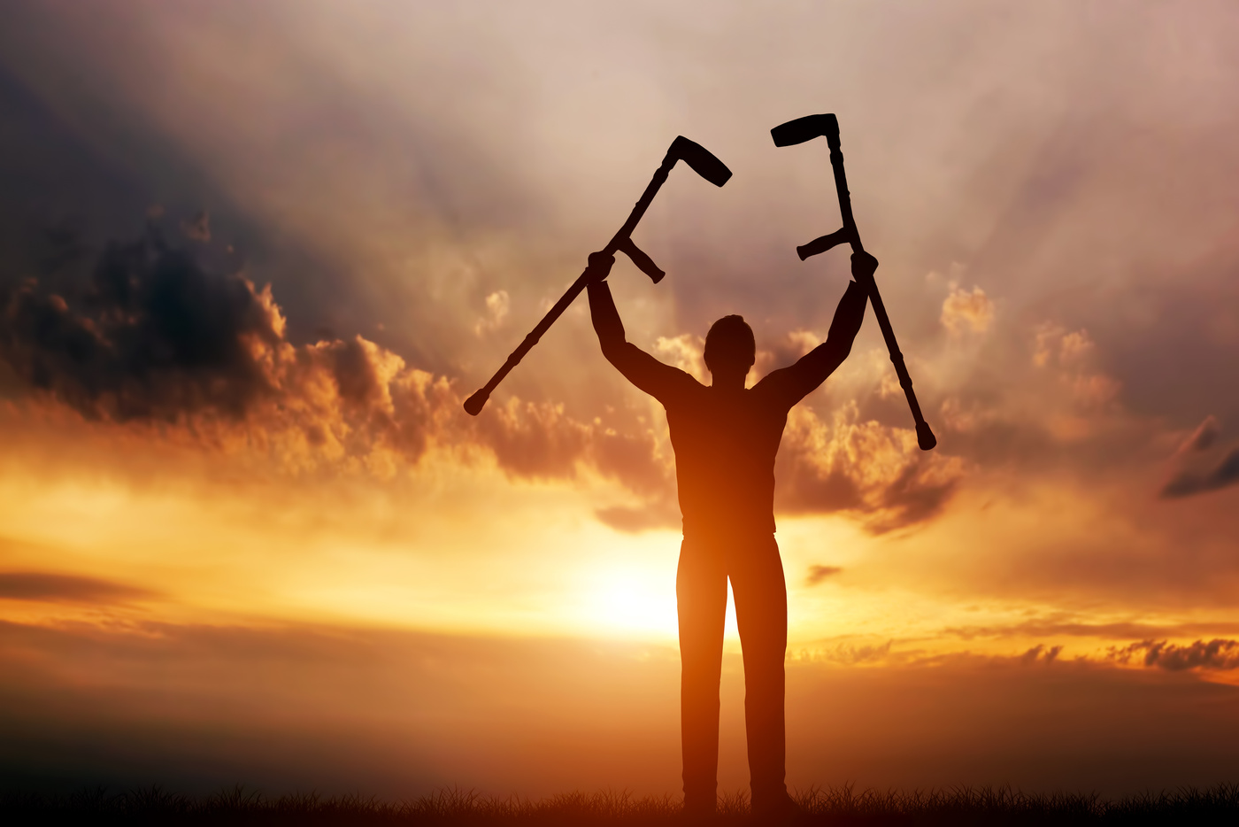 Disabled Man Raising His Crutches